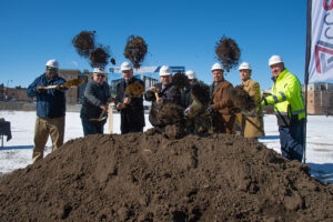Ceremonial dirst is tossed at the groundbreaking of the Breakwater 233 Apartments in the City of Racine.